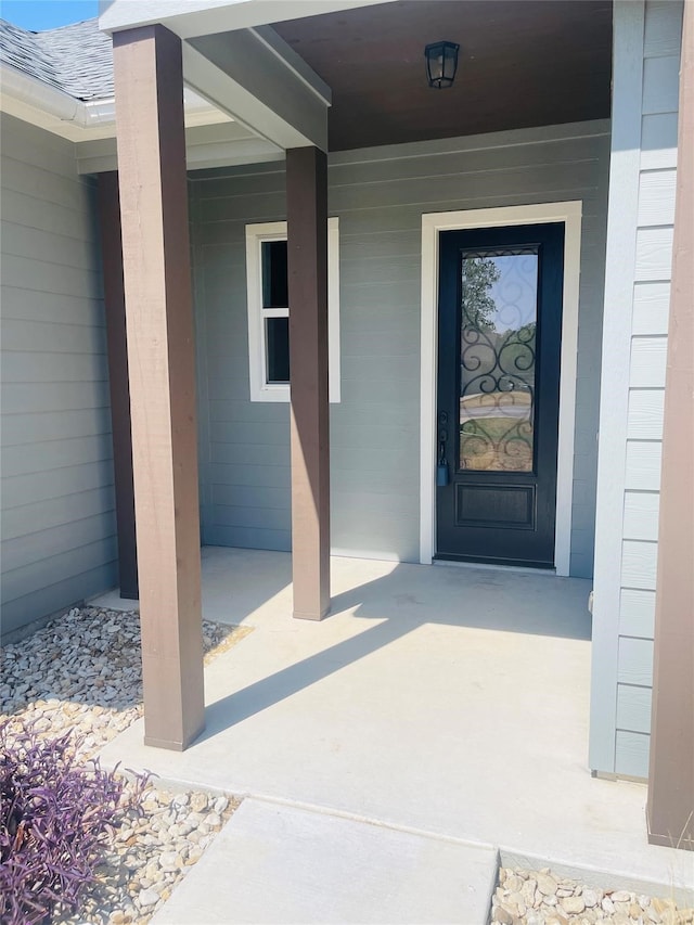 doorway to property featuring covered porch