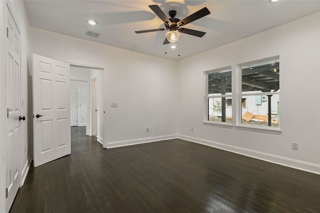 empty room featuring dark wood-type flooring and ceiling fan