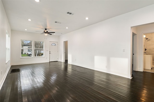 unfurnished living room featuring dark wood-type flooring, ceiling fan, and washer / clothes dryer