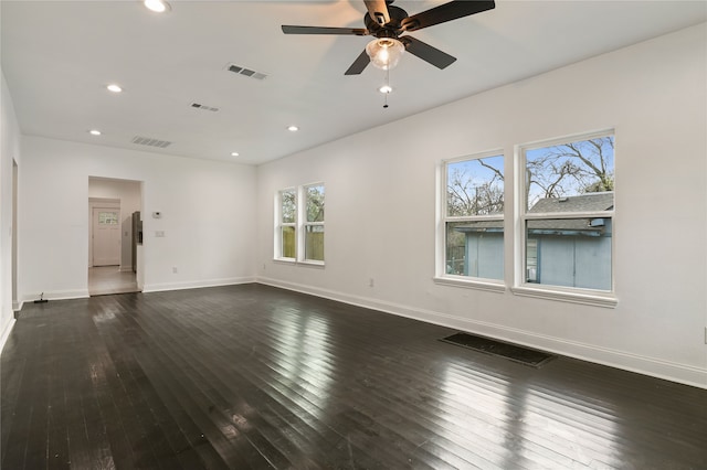 spare room with dark wood-type flooring and ceiling fan