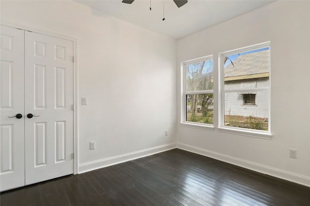 spare room with ceiling fan and dark hardwood / wood-style flooring