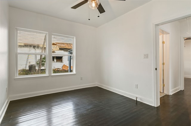 empty room with dark hardwood / wood-style flooring and ceiling fan