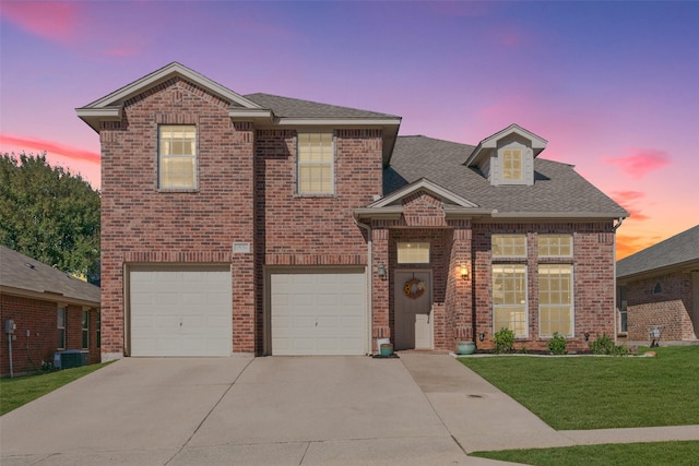 view of front of property with a garage and a yard