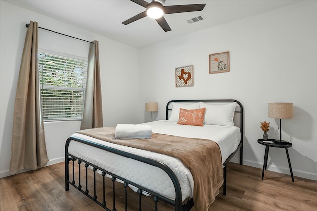 bedroom featuring dark wood-type flooring and ceiling fan