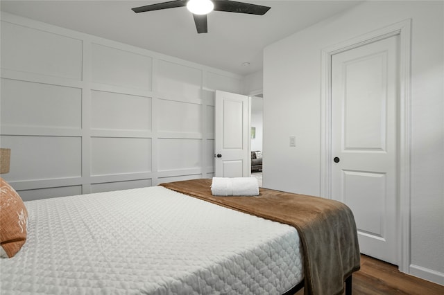 bedroom with ceiling fan and dark hardwood / wood-style flooring