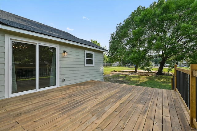 wooden terrace with a yard