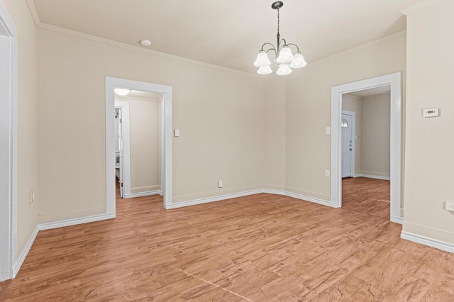 unfurnished room featuring light wood-type flooring, a chandelier, and ornamental molding