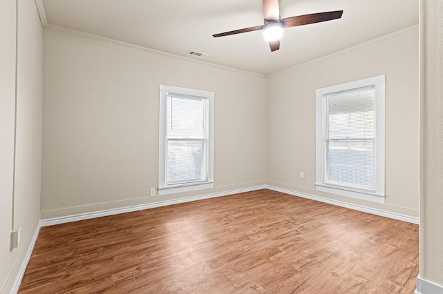 spare room with ornamental molding, hardwood / wood-style floors, a healthy amount of sunlight, and ceiling fan