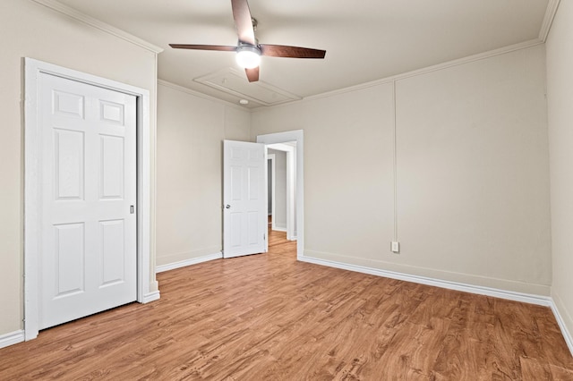 unfurnished bedroom with ceiling fan, light wood-type flooring, and ornamental molding