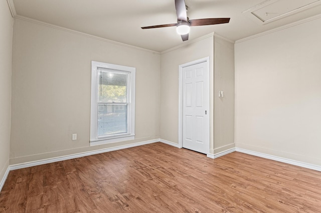 empty room with light hardwood / wood-style flooring, ceiling fan, and crown molding