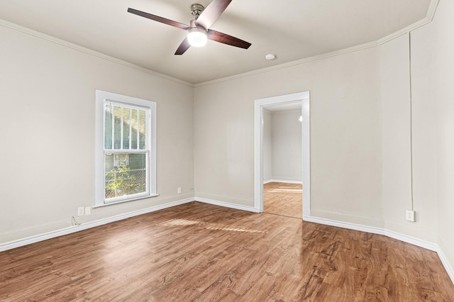 spare room with hardwood / wood-style floors, ceiling fan, and ornamental molding