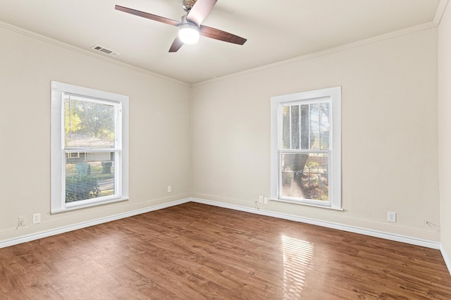 empty room featuring ceiling fan, wood-type flooring, and plenty of natural light