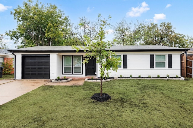 ranch-style house featuring a front yard and a garage