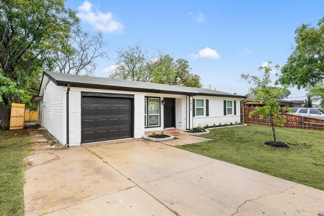 ranch-style house with a garage and a front yard