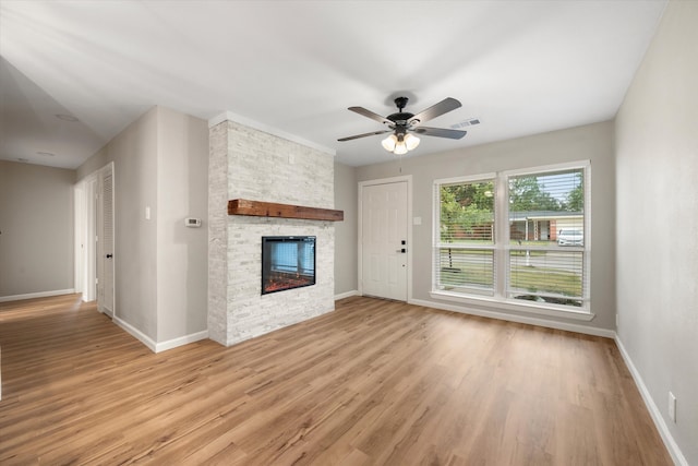 unfurnished living room featuring a fireplace, light hardwood / wood-style flooring, and ceiling fan