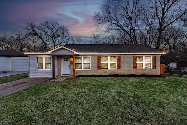 single story home with a garage and a lawn