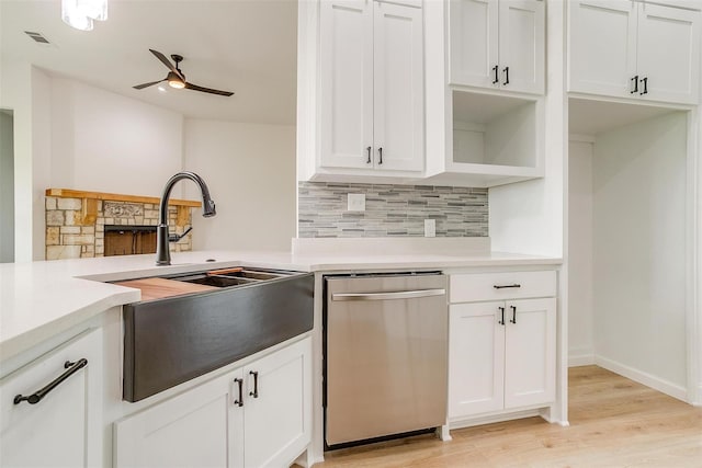 kitchen with white cabinetry, dishwasher, ceiling fan, and light wood-type flooring