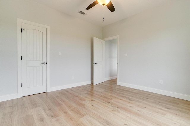 spare room with ceiling fan and light wood-type flooring