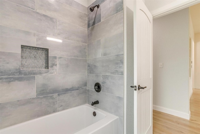 bathroom featuring tiled shower / bath combo and wood-type flooring