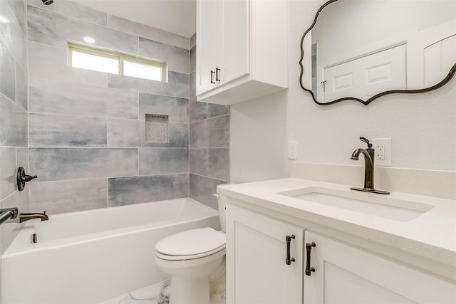 full bathroom with vanity, tiled shower / bath combo, and toilet