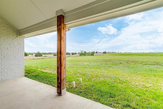 view of yard featuring a rural view and a patio area