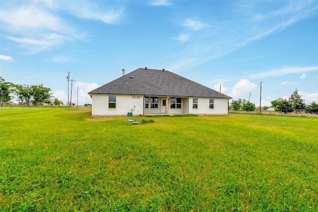 rear view of house with a lawn