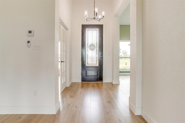 foyer with a chandelier and light hardwood / wood-style flooring