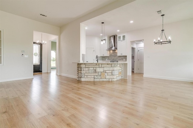 unfurnished living room with sink and light wood-type flooring