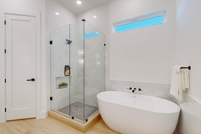 bathroom with shower with separate bathtub