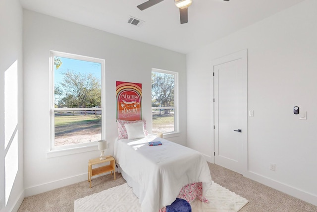 bedroom with ceiling fan and light colored carpet