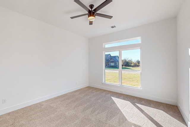 carpeted spare room with ceiling fan