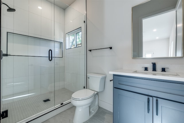 bathroom with vanity, toilet, and an enclosed shower