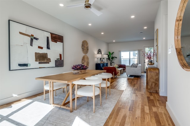 dining space featuring light wood-type flooring and ceiling fan