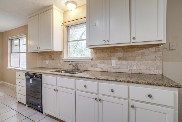 kitchen with light tile patterned flooring, a wealth of natural light, backsplash, and dishwasher