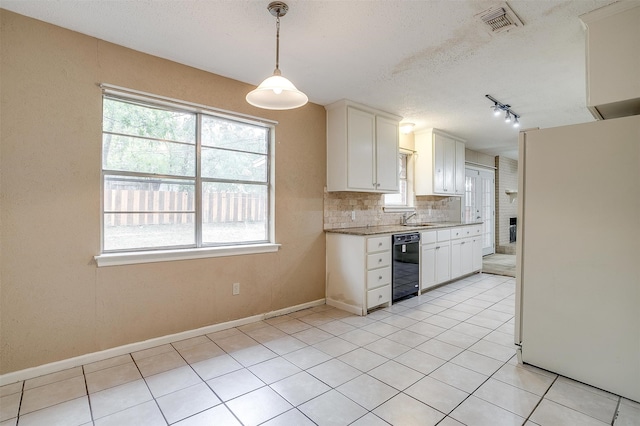 kitchen featuring white fridge, backsplash, black dishwasher, hanging light fixtures, and white cabinets