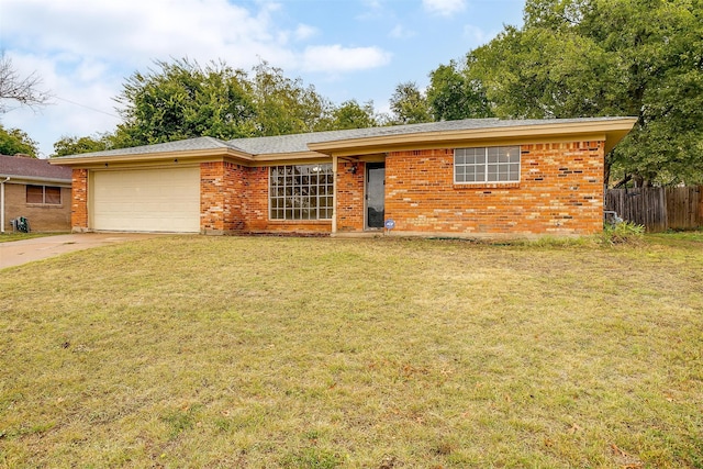 ranch-style house with a garage and a front lawn