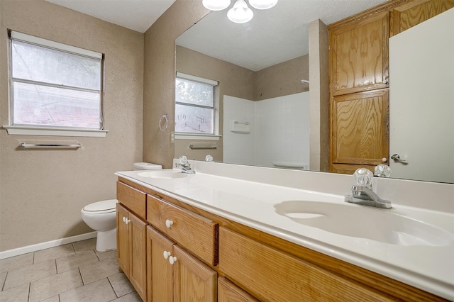 bathroom featuring vanity, tile patterned floors, toilet, and a shower