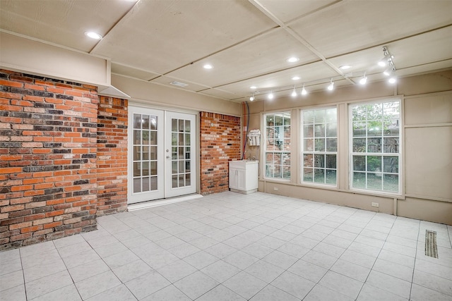 unfurnished sunroom with french doors