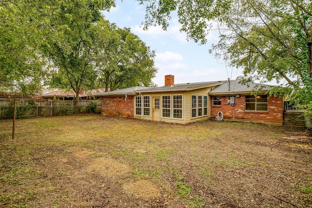 rear view of house with a lawn