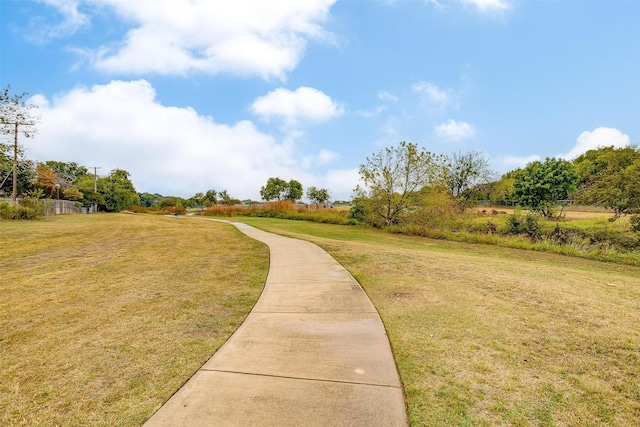 view of home's community with a yard