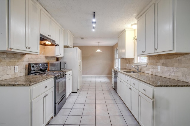 kitchen featuring light tile patterned flooring, stainless steel appliances, sink, white cabinets, and dark stone countertops