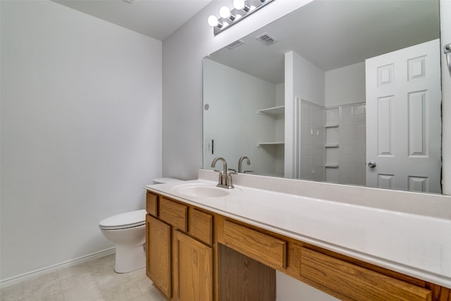 bathroom featuring toilet and vanity