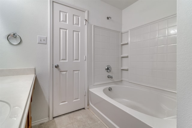 bathroom featuring vanity, tile patterned floors, and tiled shower / bath combo