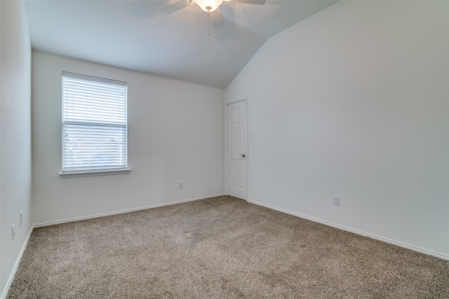 unfurnished room featuring ceiling fan, vaulted ceiling, and carpet