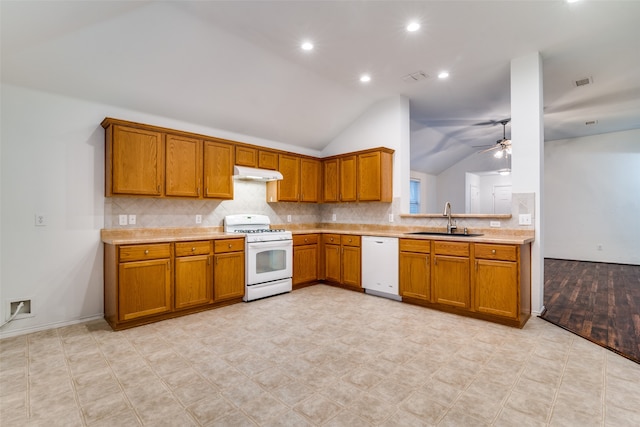 kitchen featuring lofted ceiling, decorative backsplash, sink, ceiling fan, and white appliances