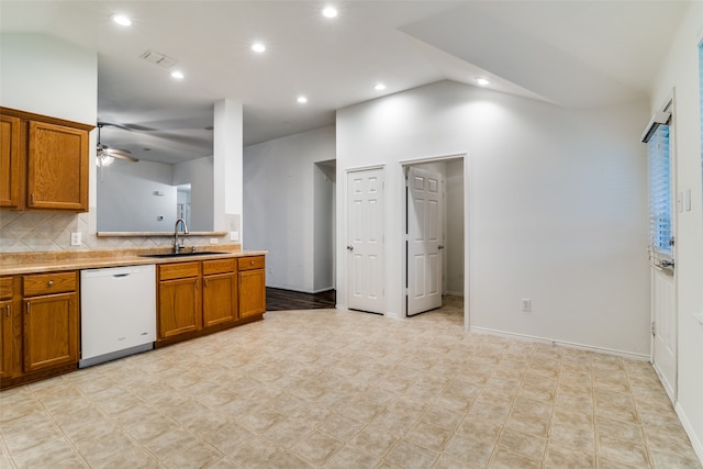 kitchen featuring sink, ceiling fan, backsplash, lofted ceiling, and dishwasher