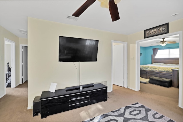 carpeted living room featuring ceiling fan