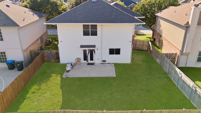 rear view of house featuring a lawn and a patio area