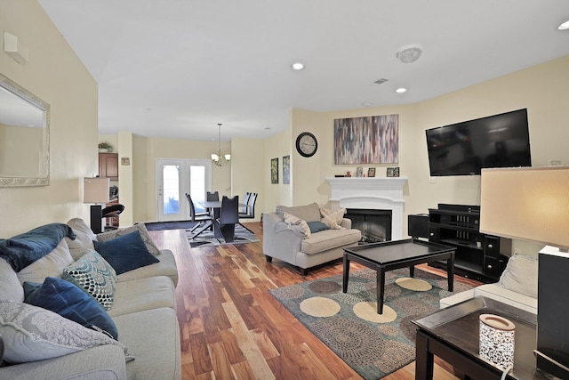 living room featuring wood-type flooring and a notable chandelier