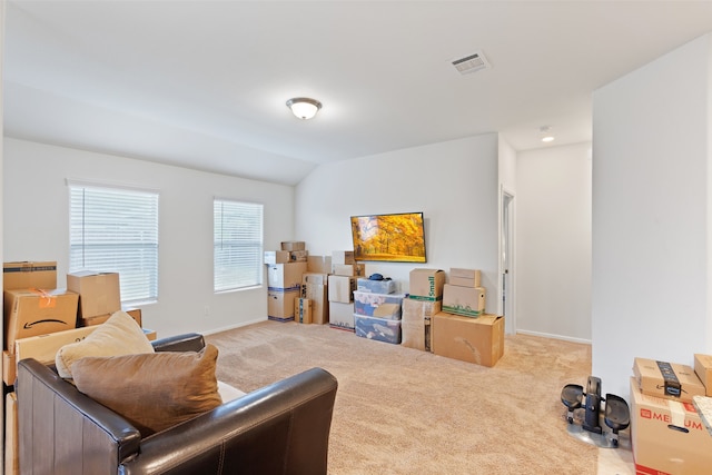 interior space featuring light colored carpet and vaulted ceiling